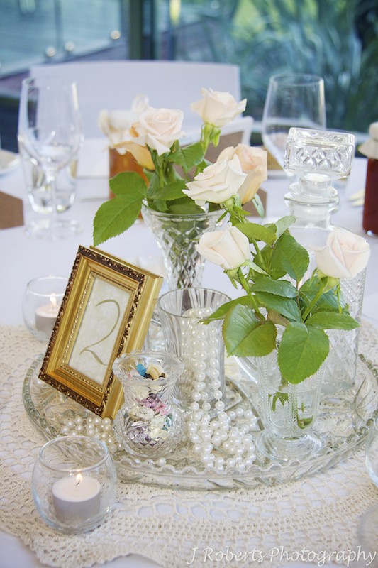 Wedding Table Settings with vases, pearls and roses = wedding photography sydney